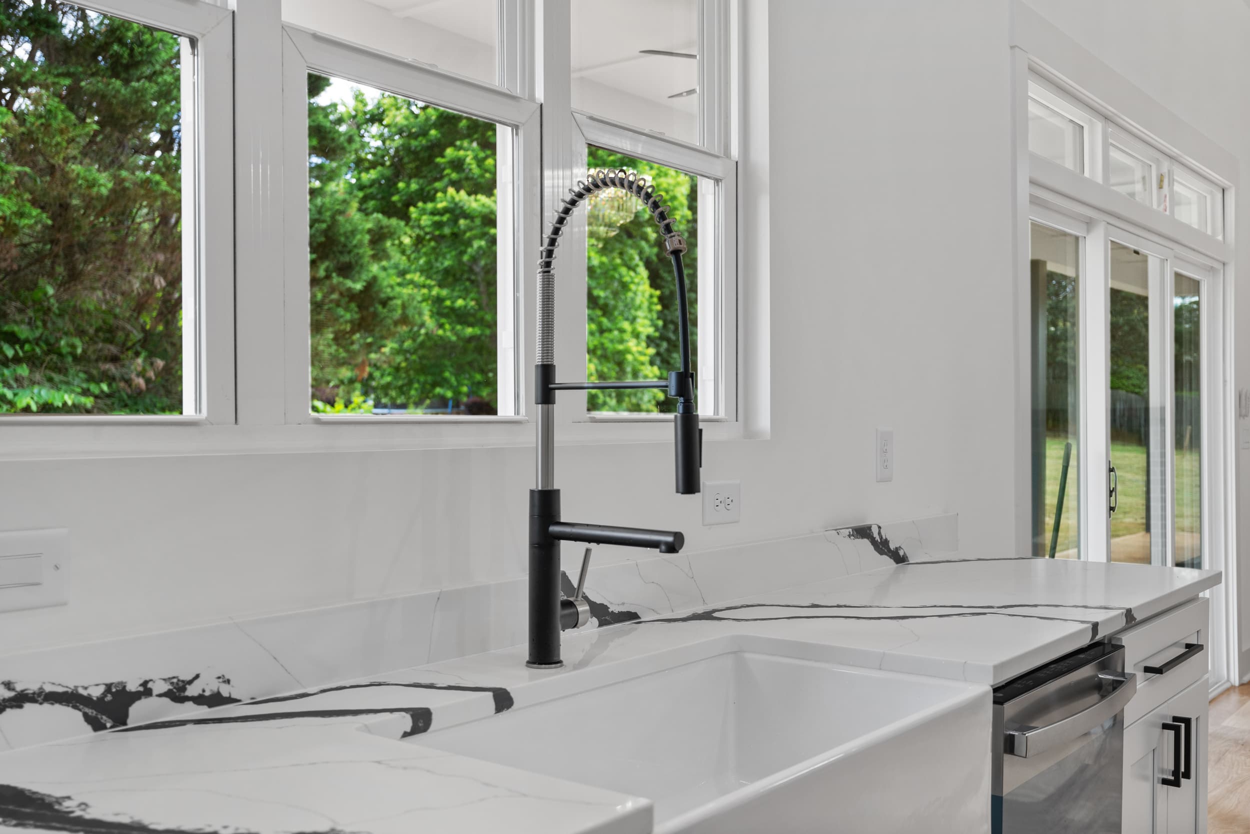 Marble counters with matte black pull-down faucet