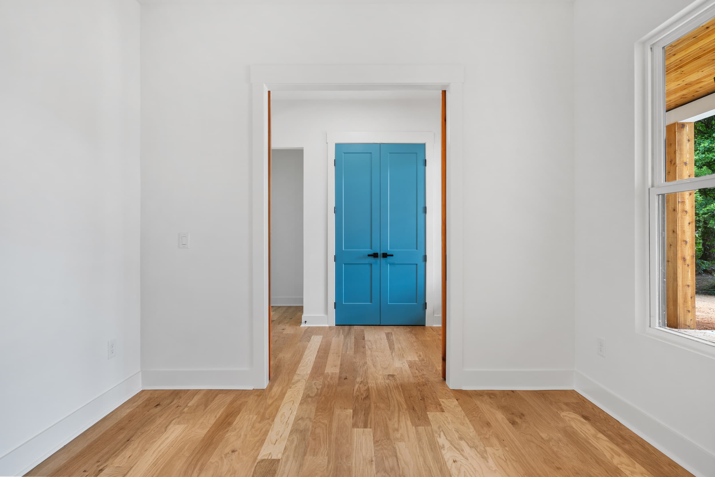Teal double doors at end of hall